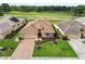 Aerial view showcasing a lovely single-Gathering home with a well-manicured lawn and attractive landscaping at 17425 Eagle Trace Dr, Brooksville, FL 34604