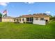 Wide view of backyard featuring a lawn, and sunroom, ideal for outdoor enjoyment at 17425 Eagle Trace Dr, Brooksville, FL 34604