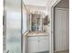 Bright bathroom featuring a glass shower, vanity with mirror, and storage at 17425 Eagle Trace Dr, Brooksville, FL 34604