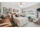 Cozy bedroom featuring a ceiling fan, window with blinds, and charming decor at 17425 Eagle Trace Dr, Brooksville, FL 34604