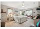 Serene primary bedroom with neutral tones, a ceiling fan, and natural light from large windows at 17425 Eagle Trace Dr, Brooksville, FL 34604