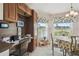 Bright breakfast nook with built-in desk area and scenic golf course views through shuttered windows at 17425 Eagle Trace Dr, Brooksville, FL 34604