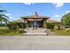 Attractive clubhouse entrance with American flag, tidy landscaping, and covered entryway at 17425 Eagle Trace Dr, Brooksville, FL 34604