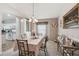 Cozy dining room with elegant chandelier, table, and view into the well-equipped kitchen at 17425 Eagle Trace Dr, Brooksville, FL 34604