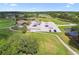 Aerial shot of a golf course clubhouse with parking lot and surrounding manicured greens at 17425 Eagle Trace Dr, Brooksville, FL 34604