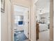 Hallway view into a clean bathroom and bedroom with a comfortable bed and bright window at 17425 Eagle Trace Dr, Brooksville, FL 34604
