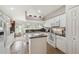 Well-lit kitchen with white cabinetry, modern appliances, and breakfast nook, perfect for casual dining at 17425 Eagle Trace Dr, Brooksville, FL 34604