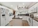 Bright kitchen featuring white cabinets, stainless steel appliances, and center island for food preparation at 17425 Eagle Trace Dr, Brooksville, FL 34604