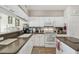 Functional kitchen featuring white cabinets, ample counter space, and modern appliances for cooking needs at 17425 Eagle Trace Dr, Brooksville, FL 34604