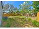 A spacious backyard featuring a wooden fence and mature trees, ideal for outdoor activities and entertaining at 1843 38Th S St, St Petersburg, FL 33711