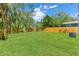 The expansive backyard features a well-maintained lawn and a wooden privacy fence at 1843 38Th S St, St Petersburg, FL 33711
