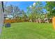 A spacious backyard featuring a wooden fence and mature trees, ideal for outdoor activities and entertaining at 1843 38Th S St, St Petersburg, FL 33711