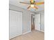 Bedroom with light wood floors, neutral paint, a ceiling fan, and closet at 1843 38Th S St, St Petersburg, FL 33711