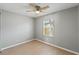 This cozy bedroom features wood-look floors, a ceiling fan, and a window providing natural light at 1843 38Th S St, St Petersburg, FL 33711
