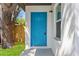 Close-up of the beautiful, bright blue front door and surrounding textured stucco wall at 1843 38Th S St, St Petersburg, FL 33711