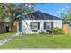 Charming home with a well-manicured lawn, black shutters, and a welcoming blue front door at 1843 38Th S St, St Petersburg, FL 33711