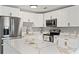 Bright kitchen features white cabinets, stainless steel appliances and island with quartz countertops at 1843 38Th S St, St Petersburg, FL 33711