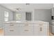 Spacious white kitchen island with quartz countertop and gold hardware offers ample storage at 1843 38Th S St, St Petersburg, FL 33711