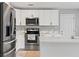 Bright modern kitchen with stainless steel appliances, white cabinetry, and quartz countertops at 1843 38Th S St, St Petersburg, FL 33711