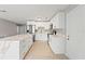 Bright open kitchen showcases white cabinets, stainless appliances, and a large island at 1843 38Th S St, St Petersburg, FL 33711
