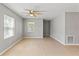 Open-concept living room with neutral paint, ceiling fan and lots of natural light at 1843 38Th S St, St Petersburg, FL 33711