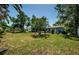Expansive backyard with mature trees and lush grass, offering ample space for outdoor activities at 1942 Ashland Dr, Clearwater, FL 33763