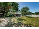 Well-maintained backyard with mature trees, screened-in porch, providing a serene outdoor space at 1942 Ashland Dr, Clearwater, FL 33763