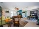 Inviting living area with tile flooring, ceiling fan, and views into dining area and kitchen at 1942 Ashland Dr, Clearwater, FL 33763