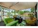Cozy screened-in porch with stylish seating and a view of the fenced backyard at 1942 Ashland Dr, Clearwater, FL 33763