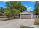 Attractive home with a long driveway, two-car garage, and well-manicured landscaping at 2001 Hudson Ct, Oldsmar, FL 34677