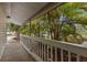Relaxing covered porch offers scenic views framed by lush tropical foliage at 2001 Hudson Ct, Oldsmar, FL 34677