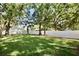 Spacious backyard with lush lawn, mature trees, and white privacy fence at 2004 Chickwood Ct, Tampa, FL 33618