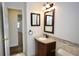 Bathroom with modern vanity, decorative mirror, and doorway leading into an adjacent hallway at 2004 Chickwood Ct, Tampa, FL 33618