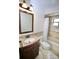 Bathroom with updated vanity, decorative tile and bathtub with shower at 2004 Chickwood Ct, Tampa, FL 33618