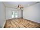 Bedroom features wood-look floors, a sliding glass door, and backyard access at 2004 Chickwood Ct, Tampa, FL 33618