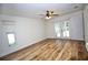 Bright bedroom features wood-look floors and access to the backyard at 2004 Chickwood Ct, Tampa, FL 33618