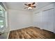 Bedroom featuring wood-look floors, a window and closet with folding doors at 2004 Chickwood Ct, Tampa, FL 33618