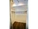 Empty walk-in closet featuring wood floors and open shelving, ready for customization at 2004 Chickwood Ct, Tampa, FL 33618