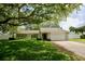 A lovely home with stone accents and a two-car garage, complemented by a well-kept lawn and mature trees at 2004 Chickwood Ct, Tampa, FL 33618