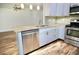 Kitchen features stainless appliances, granite countertops, and wood-look flooring at 2004 Chickwood Ct, Tampa, FL 33618