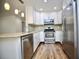 Updated kitchen with stainless steel appliances and granite countertops provides beauty and functionality at 2004 Chickwood Ct, Tampa, FL 33618
