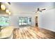 Open-concept living area with bar seating, wood-look floors and sliding glass doors to patio at 2004 Chickwood Ct, Tampa, FL 33618