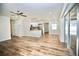 Open-concept living space with wood-look floors, kitchen, and sliding glass doors at 2004 Chickwood Ct, Tampa, FL 33618