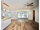 Open floor plan boasting wood-look floors, bar seating and views of the pool area at 2004 Chickwood Ct, Tampa, FL 33618