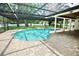 A kidney shaped pool is surrounded by brick pavers in this backyard view at 2004 Chickwood Ct, Tampa, FL 33618