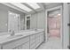Bathroom features a large mirror, double sinks, and access to the shower for added convenience at 2023 Golfview Dr # 2023, Tarpon Springs, FL 34689