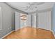 Bright bedroom featuring wood floors and easy access to the kitchen through open doorways, creating a flowing layout at 2023 Golfview Dr # 2023, Tarpon Springs, FL 34689
