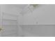 Walk-in closet with built-in shelving provides ample storage space for clothing and accessories at 2023 Golfview Dr # 2023, Tarpon Springs, FL 34689