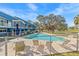 Community pool with lounge chairs and blue exterior, an idyllic place to relax and unwind at 2023 Golfview Dr # 2023, Tarpon Springs, FL 34689