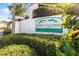 A sign for Green Dolphin Villas, Garden & Golf Course Condominiums, is surrounded by greenery at 2023 Golfview Dr # 2023, Tarpon Springs, FL 34689